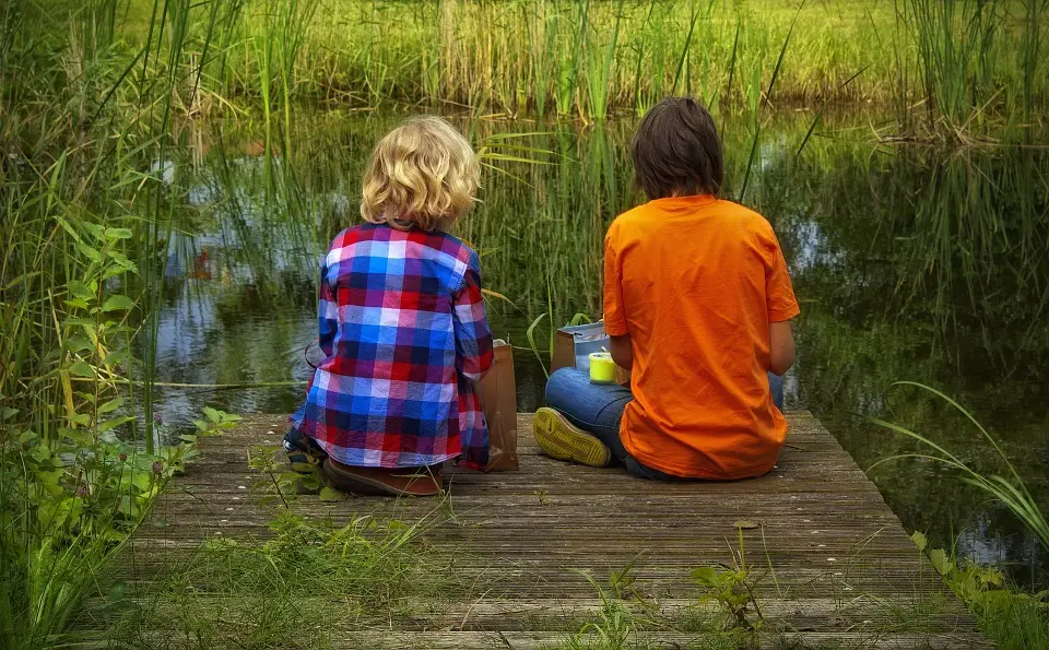 Friends sat by the water