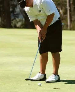 Golfer putting on the green